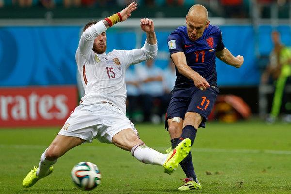 Arjen Robben kicks the ball past Spain's Sergio Ramos to score the Netherlands' second goal