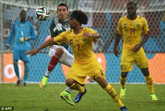 Hector Herrera (left) fights for the ball with Cameroon's Benoit Assou-Ekotto
