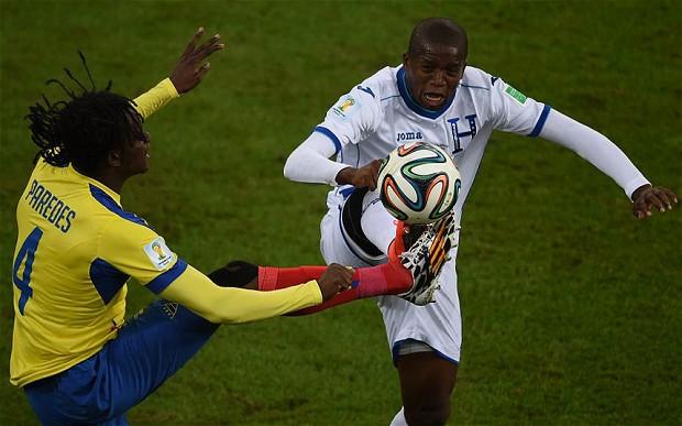 Ecuador's Juan Carlos Parede vies for the ball with Honduras midfielder