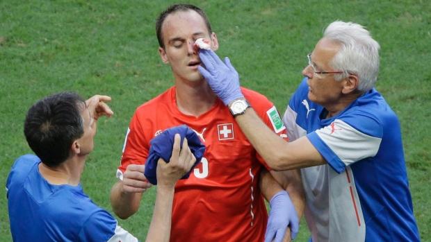 Switzerland's Steve von Bergen, getting treatment after being injured