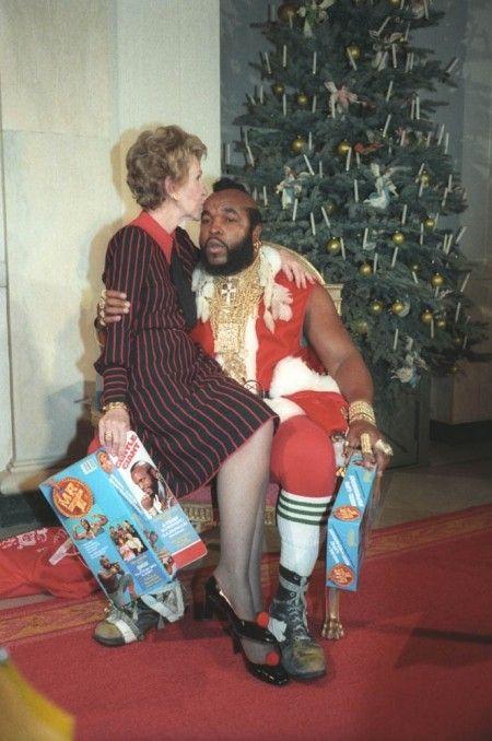 Former First Lady Nancy Reagan sitting on the lap of Mr. T dressed as 