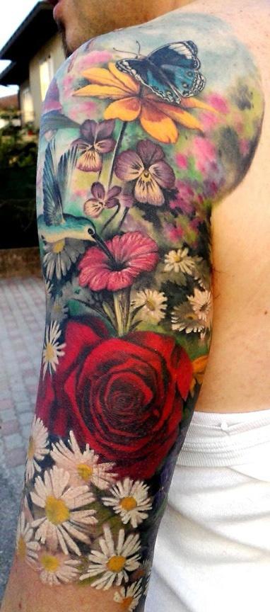 Beautiful vivid colors! Stunning floral sleeve tattoo.