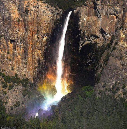 A waterfall in Yosemite that turns rainbow when the sun strikes it fro