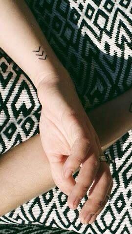 Small chevron tattoo which means create your own reality