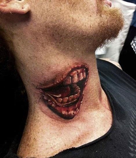 Yikes! This guy has two mouths, or so it seems. This tattoo is just pl