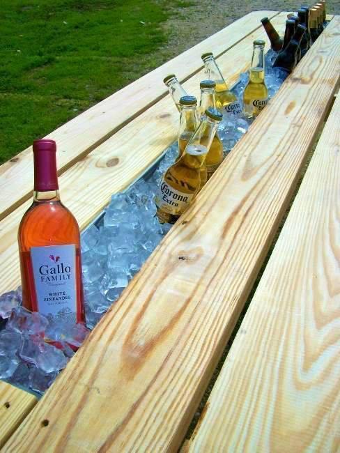 Replace board of picnic table with rain gutter. Fill with ice and enjo