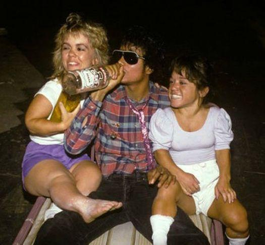 Michael Jackson... chugging vodka... 2 midgets on his lap... one holdi