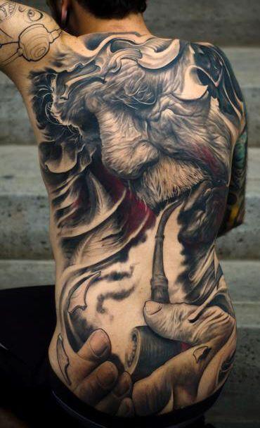 very realistic looking tattoo of an old man (maybe Gandolf) smoking a 