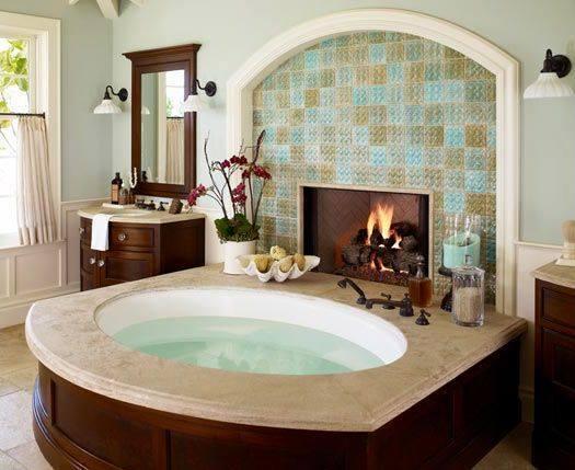 Tiled fireplace next to a nice big spa bath tub
