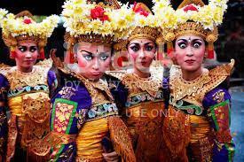 Adult female Balinese dancers pull funny faces