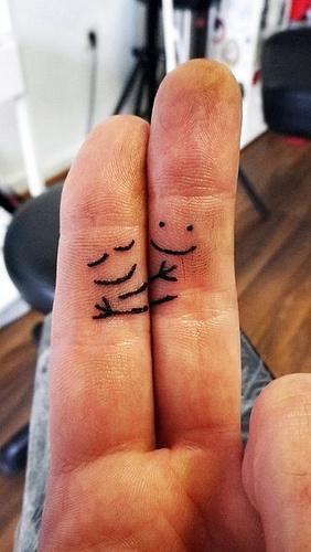 finger hug tattoo